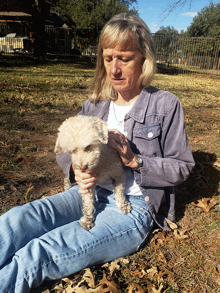20260106_135252-ANIMATION Lisa holding a little poodle / jack russel in the yard - animated gif